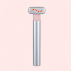 A silver T-shaped lip balm tube with a pink inner balm chamber and a small red and yellow wavy accent on the top cap, centered on a pale pink background.
